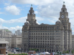 Royal Liver Building, Cunard Building, and Port of Liverpool Building. Dora saw these buildings when she was saying good-bye to Edward
